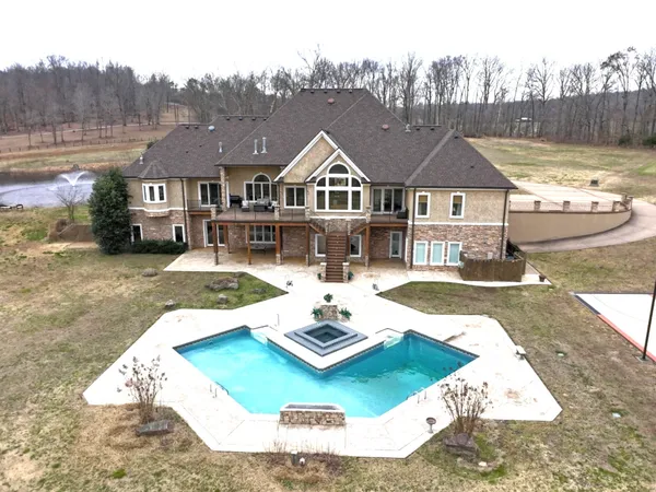 a view of a house with swimming pool and sitting area