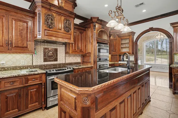 a bathroom with a granite countertop toilet sink and mirror