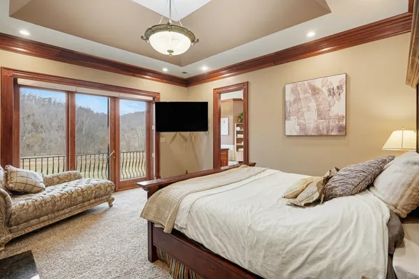 a bedroom with a bed and a chandelier