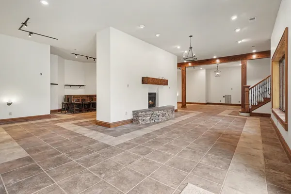 a kitchen with stainless steel appliances granite countertop a refrigerator a stove top oven a sink and dishwasher with wooden floor