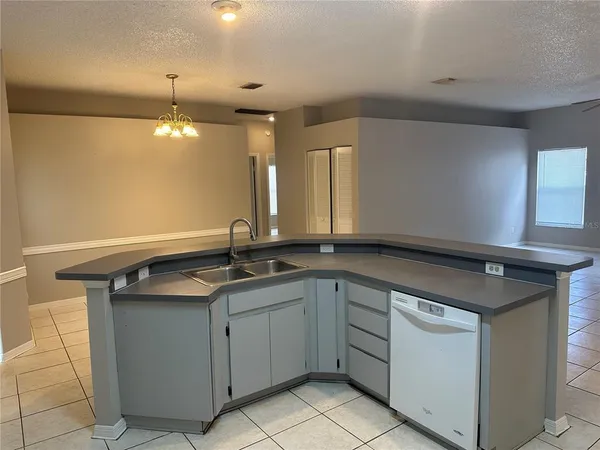 a kitchen with a sink and a refrigerator