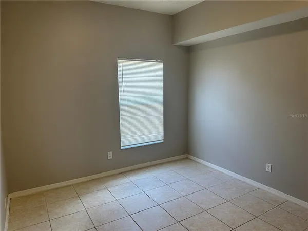 a bathroom with a granite countertop toilet and a sink