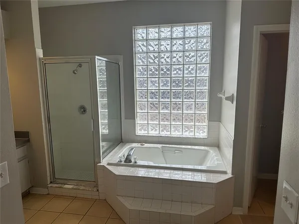 a bathroom with bathtub and window