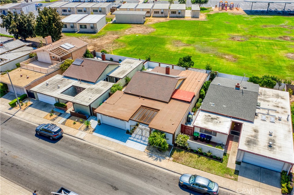 an aerial view of a house with garden space and street view