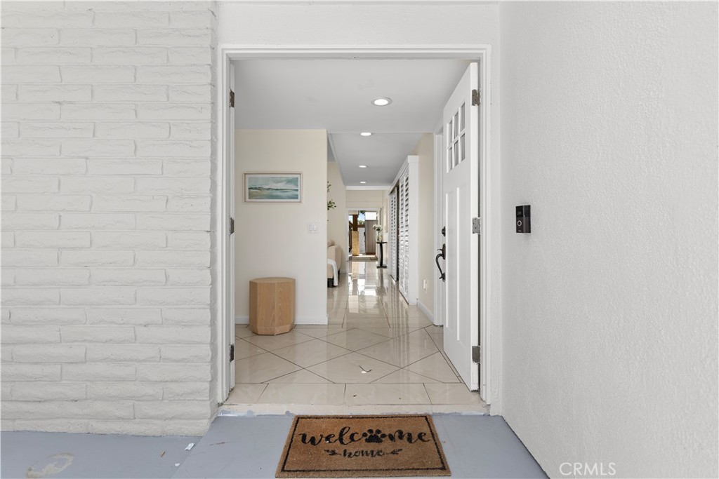 14332 Kipling Lane Tustin, CA 92780 - Photo 4 of 16 a view of a hallway with wooden floor and a bathroom