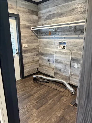 a view of a room with wooden floor