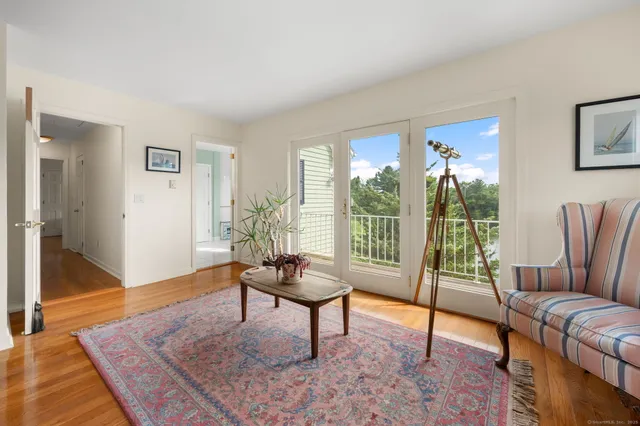 a living room with furniture and a floor to ceiling window