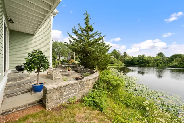 a view of a lake with a house in the background