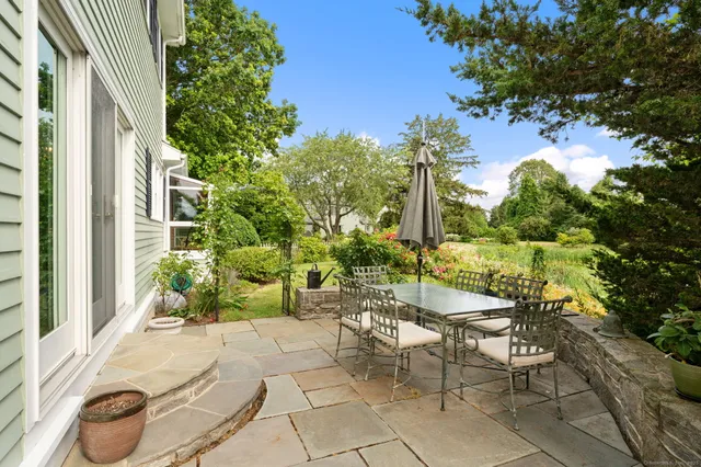 a view of a patio with table and chairs and potted plants