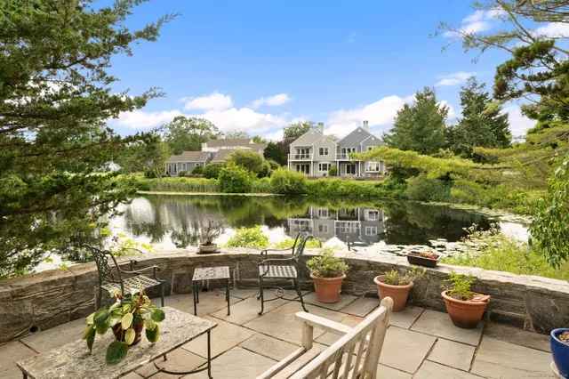 a view of a lake with couches and wooden floor