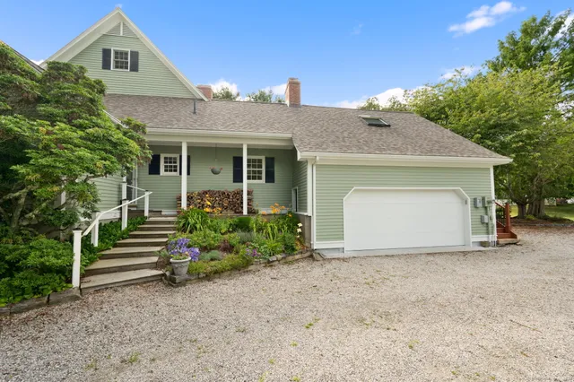 a front view of a house with a garden
