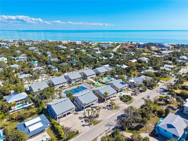 an aerial view of a building with ocean view