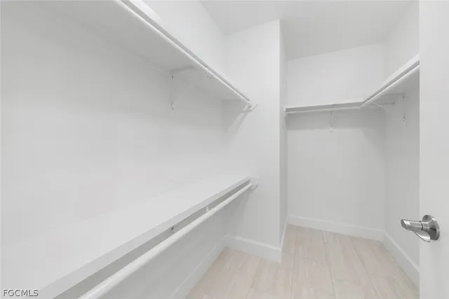 a bathroom with a shower sink vanity mirror and toilet