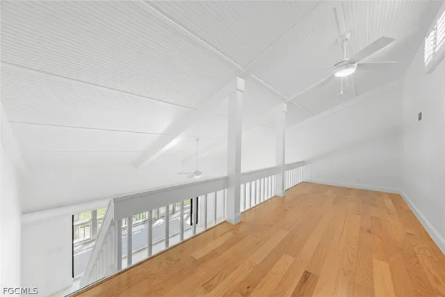 a view of a swimming pool with lawn chairs under an umbrella