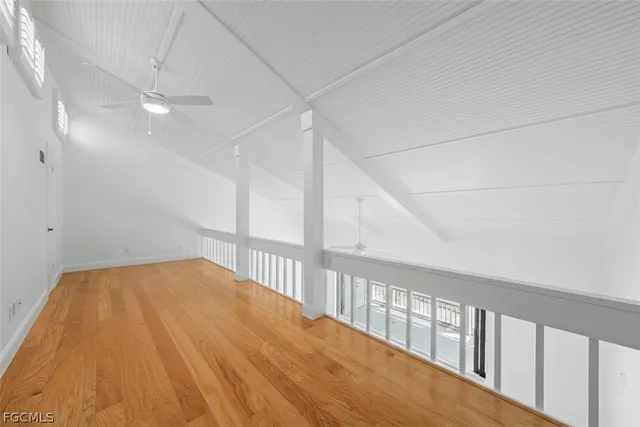 a view of a patio with table and chairs potted plants and palm tree