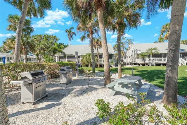 a view of a house with backyard porch and sitting area
