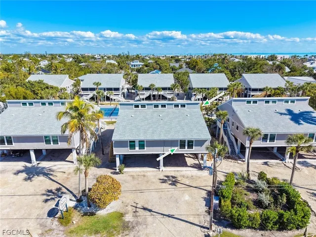 an aerial view of a house with yard swimming pool and outdoor seating