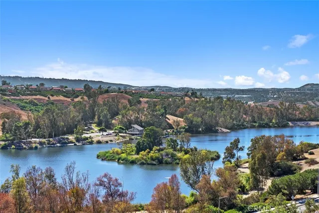 a front view of multi story residential apartment building with yard and green space