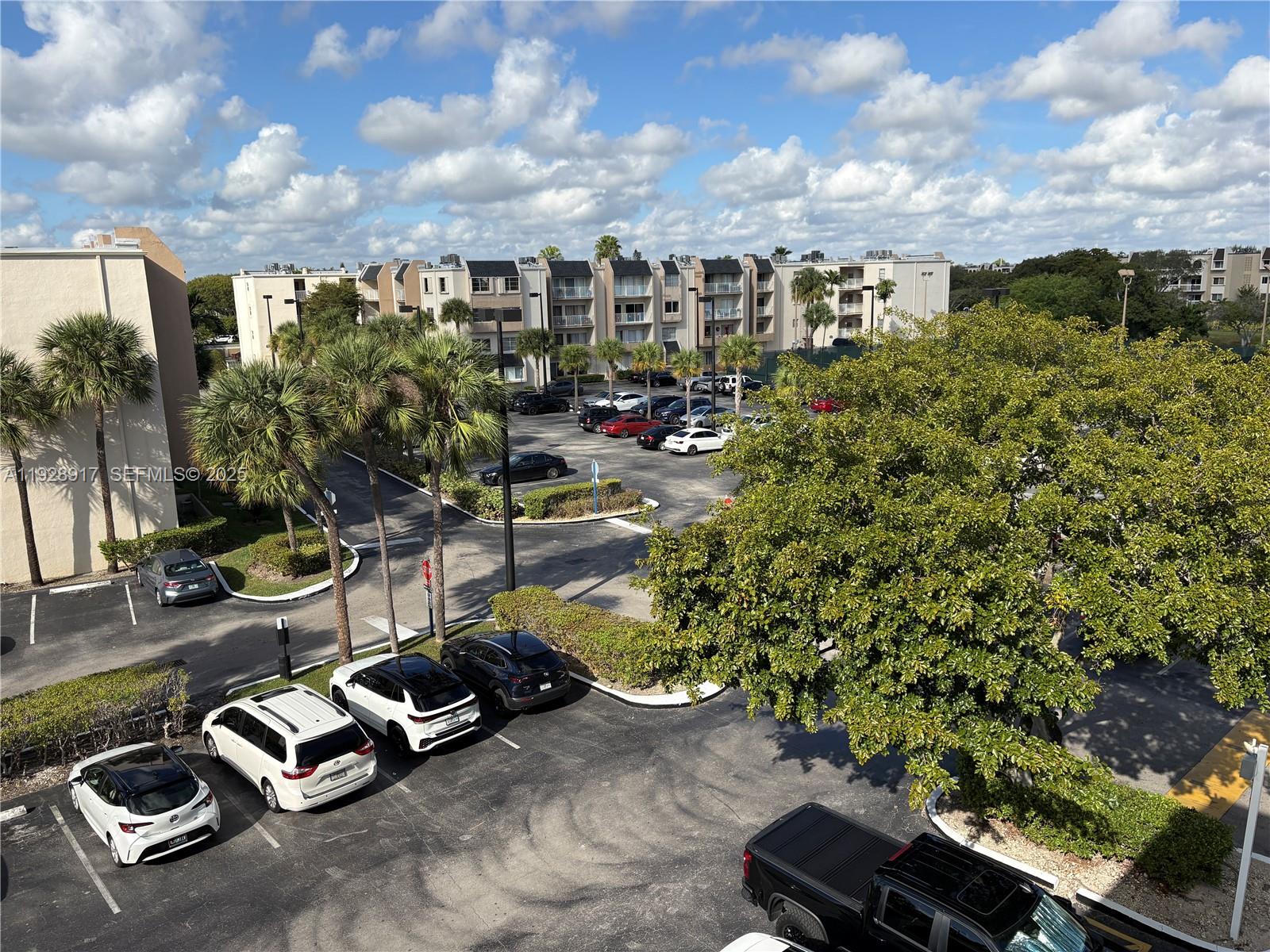 7747 Southwest 86th Street, Unit D411 Miami, FL 33143 - Photo 12 of 17 a view of a street with sitting area