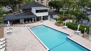 7747 Southwest 86th Street, Unit D411 Miami, FL 33143 - Photo 13 of 17 a view of a patio with table and chairs and potted plants