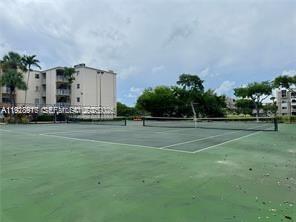 7747 Southwest 86th Street, Unit D411 Miami, FL 33143 - Photo 15 of 17 a front view of a house with a yard
