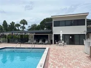 a view of a swimming pool with a patio and a garden