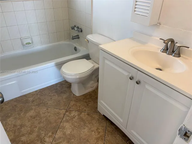 a bathroom with a sink a toilet and bathtub