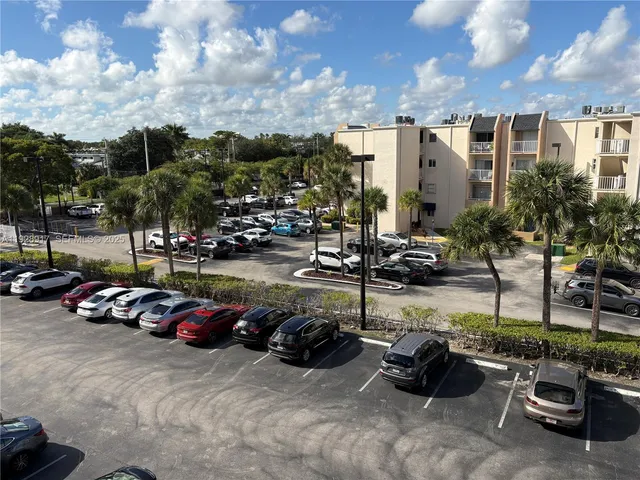 a view of a parking space with cars park