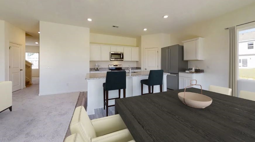217 Rodgers Road Taylor, TX 76574 - Photo 3 of 13 a kitchen with kitchen island granite countertop a sink and a refrigerator