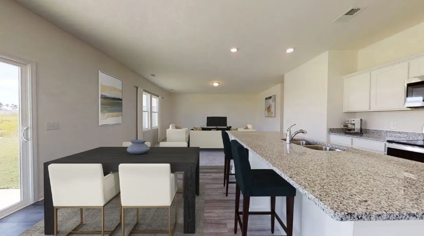 217 Rodgers Road Taylor, TX 76574 - Photo 4 of 13 a large kitchen with a table chairs and a refrigerator