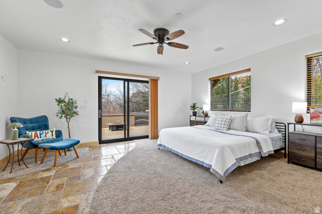 98 Bridge Road Rockville, UT 84763 - Photo 32 of 75 2nd Floor – Bedroom #4 with Sliding Glass Door to Deck. Bedroom with stone tile flooring, access to outside, multiple windows, ceiling fan, and recessed lighting