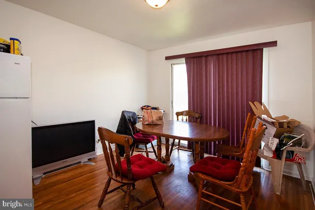 a view of a workspace with furniture and wooden floor