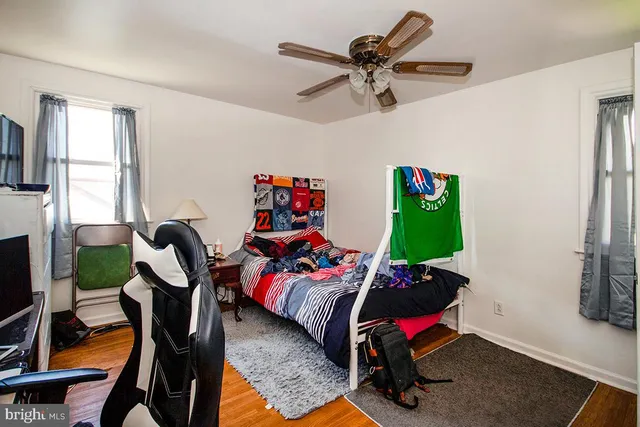 a living room with furniture gym equipment and a flat screen tv