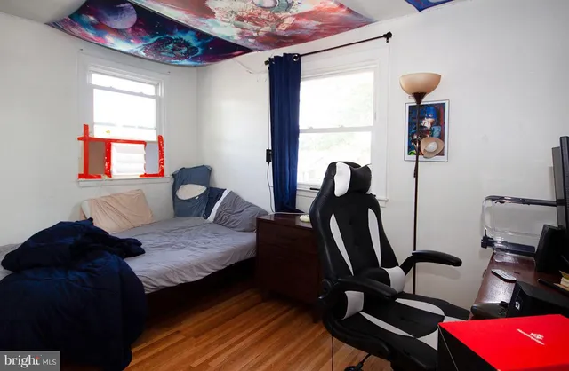a living room with furniture a window and gym equipment