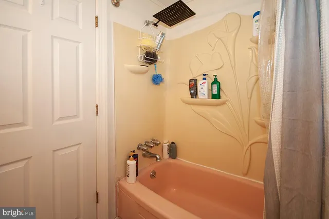 a bathroom with a tub and shower