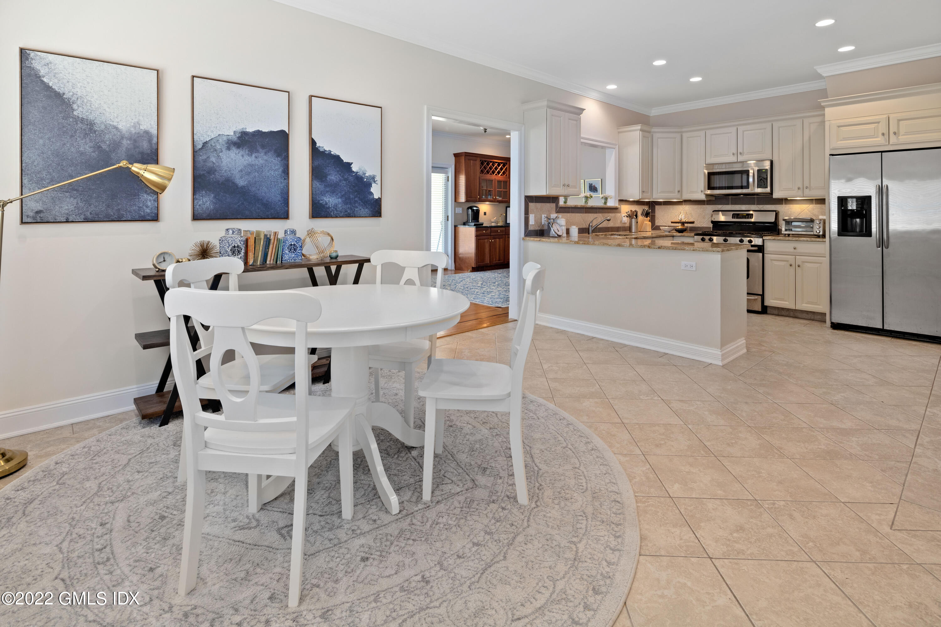 a kitchen with stainless steel appliances kitchen island granite countertop a refrigerator and microwave