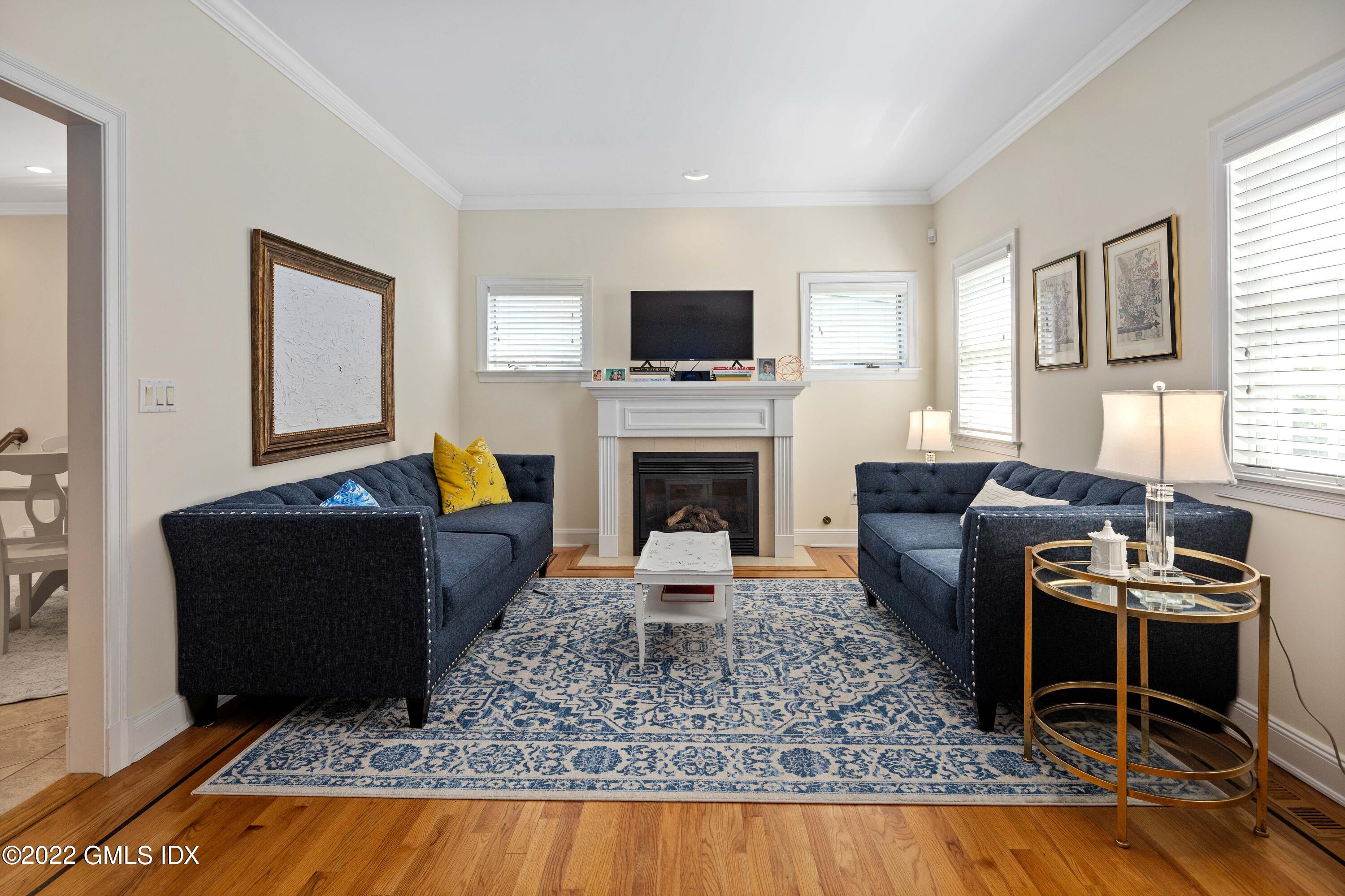 34 Windy Knolls, Unit B Greenwich, CT 06831 - Photo 13 of 37 a living room with furniture a flat screen tv and a fireplace
