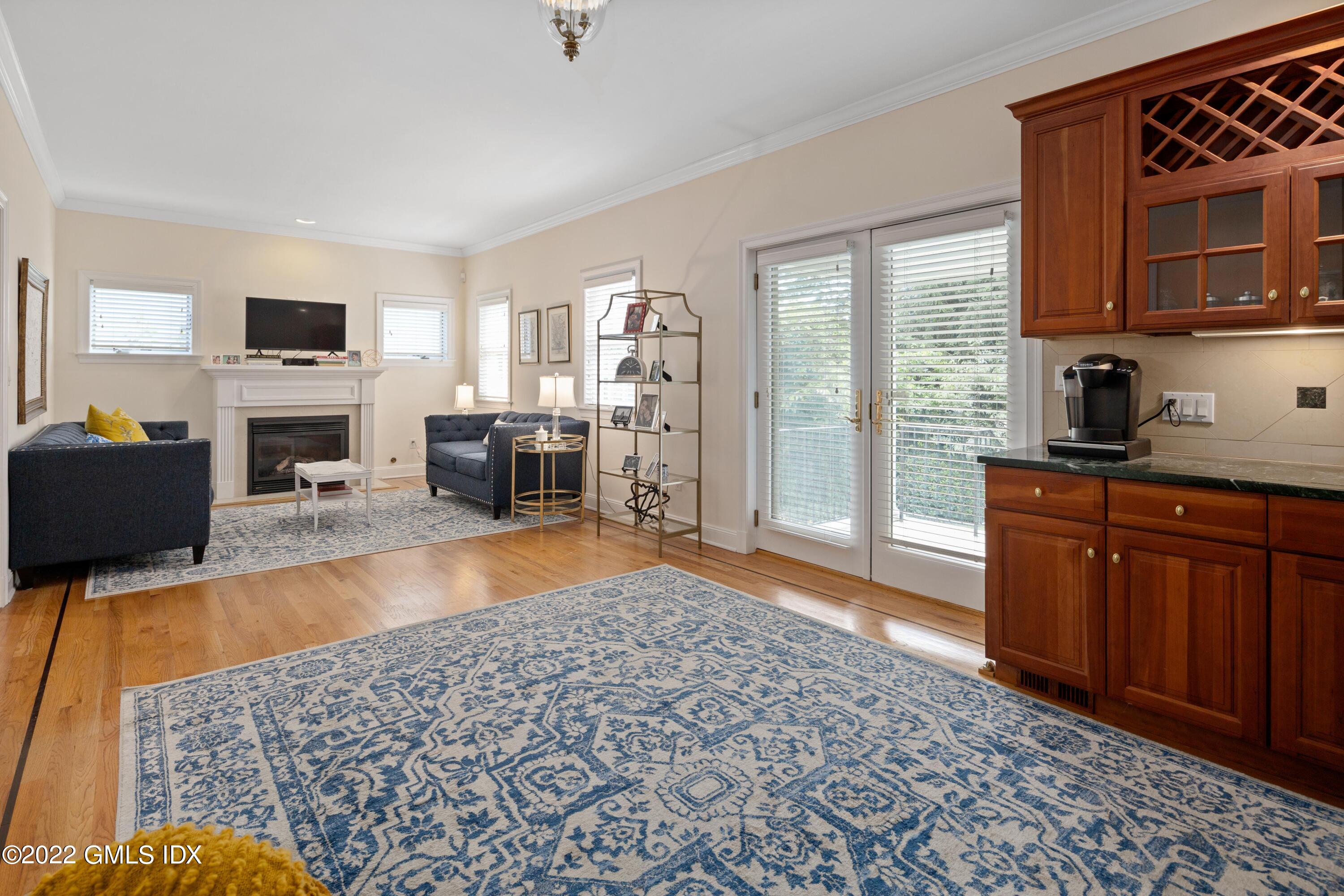 34 Windy Knolls, Unit B Greenwich, CT 06831 - Photo 19 of 37 a living room with furniture a flat screen tv and a fireplace