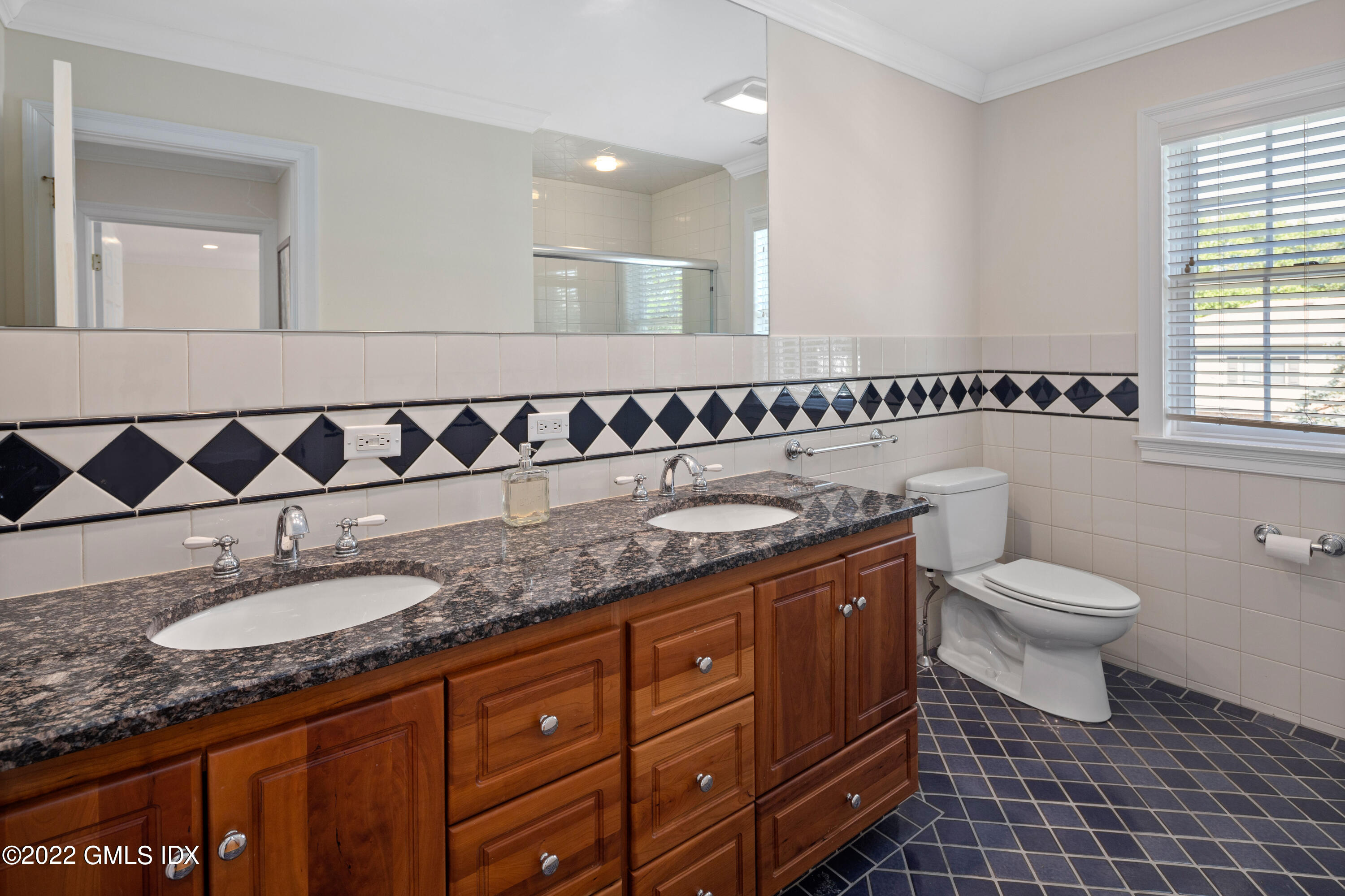 34 Windy Knolls, Unit B Greenwich, CT 06831 - Photo 22 of 37 a bathroom with a granite countertop sink a mirror a toilet and a shower