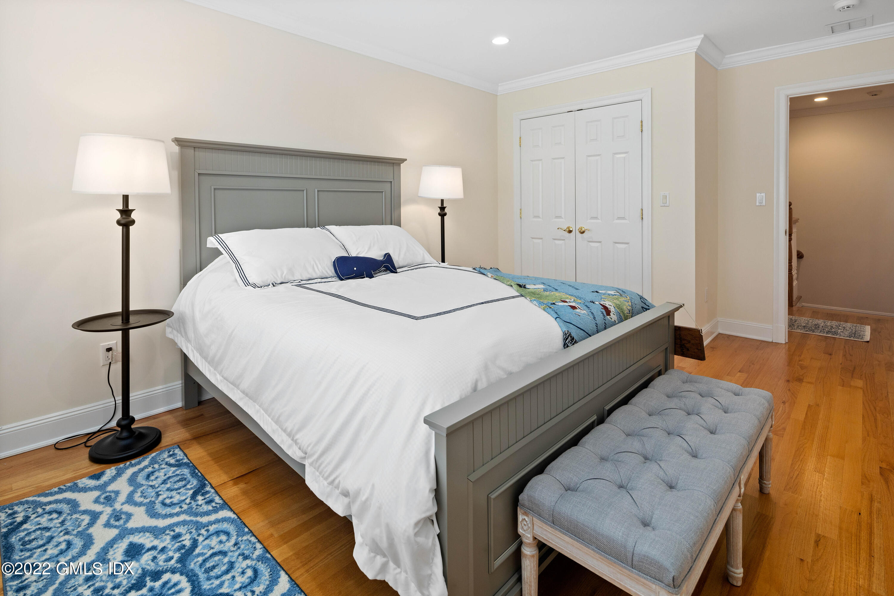 34 Windy Knolls, Unit B Greenwich, CT 06831 - Photo 30 of 37 a bed room with a bed and a lamp