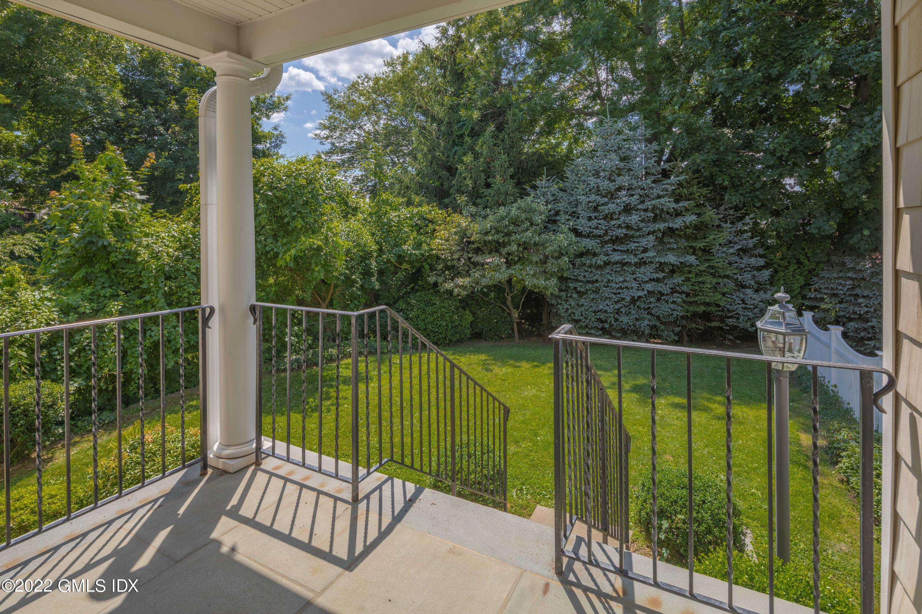 34 Windy Knolls, Unit B Greenwich, CT 06831 - Photo 31 of 37 a view of a balcony with floor to ceiling window and wooden fence