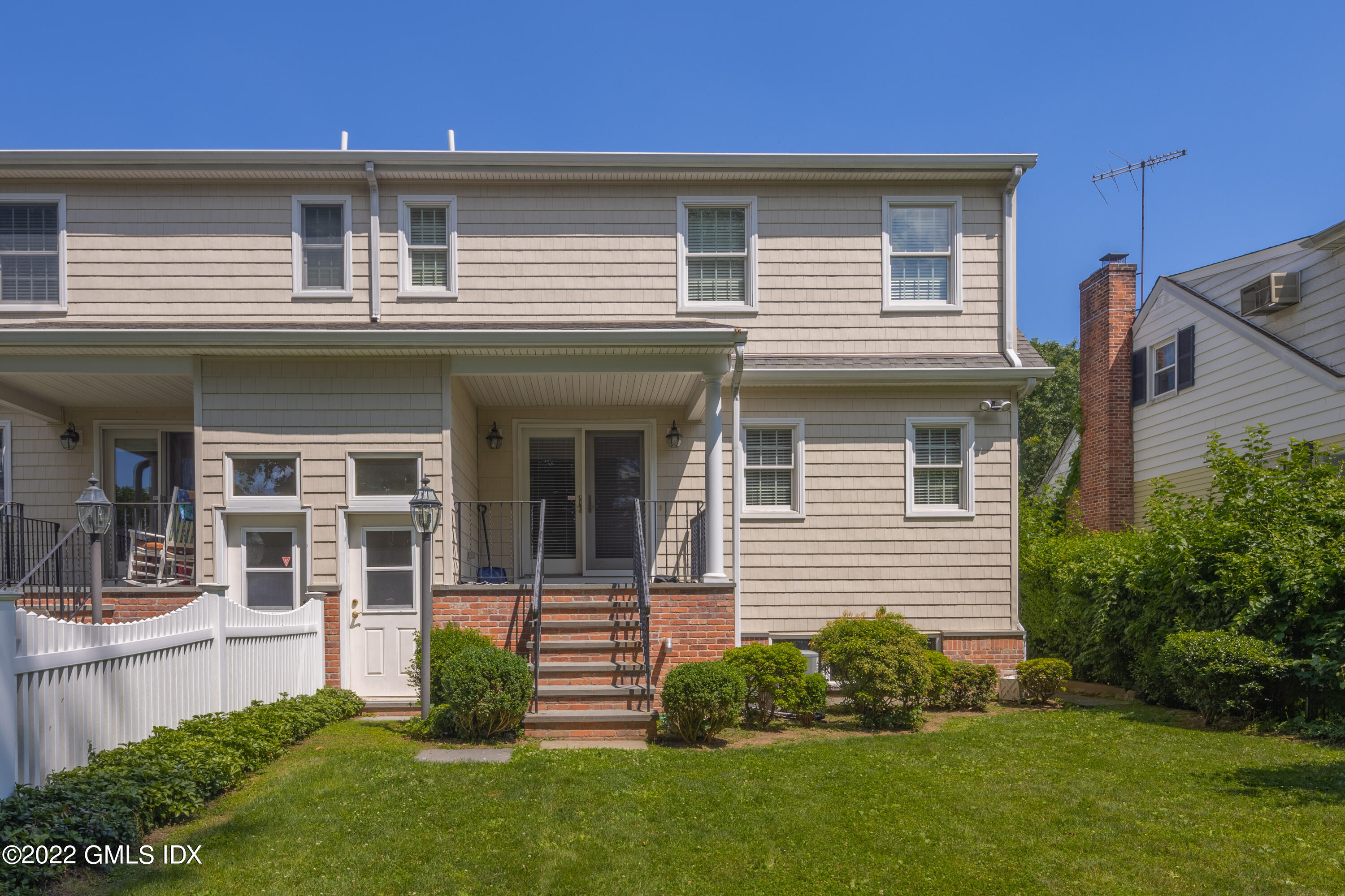 34 Windy Knolls, Unit B Greenwich, CT 06831 - Photo 32 of 37 a front view of a house with a garden