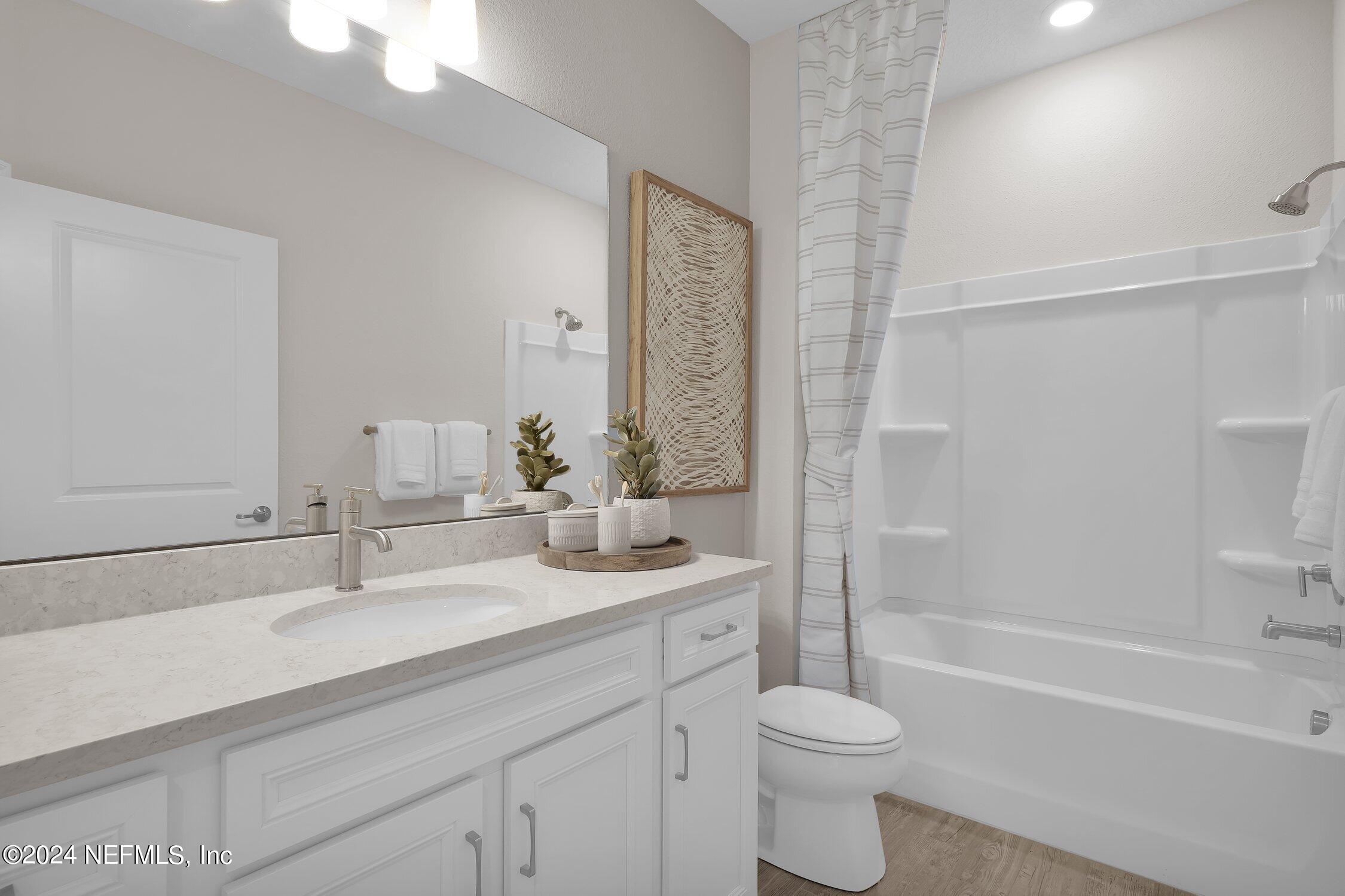 330 Salt Meadow Loop Yulee, FL 32097 - Photo 15 of 20 a bathroom with a granite countertop sink toilet and shower