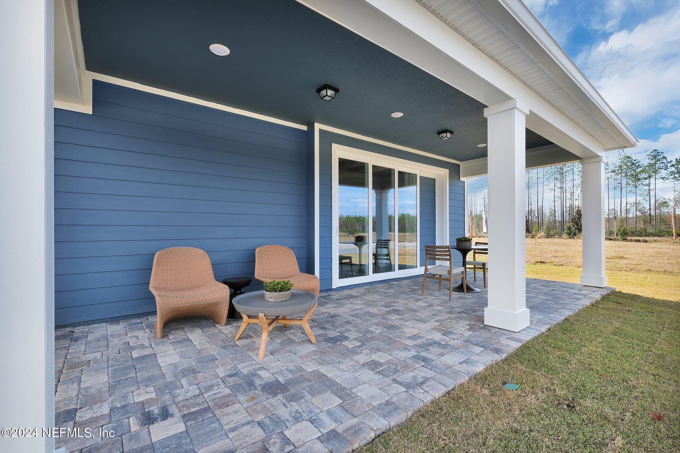 330 Salt Meadow Loop Yulee, FL 32097 - Photo 17 of 20 a building outdoor space with patio furniture and potted plants