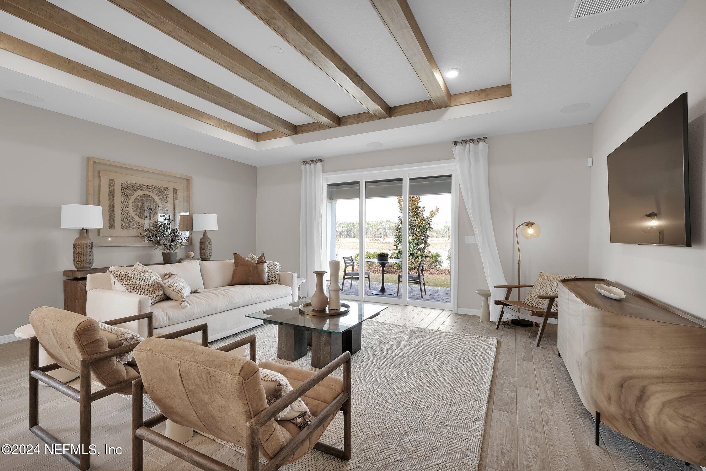 330 Salt Meadow Loop Yulee, FL 32097 - Photo 7 of 20 a living room with furniture and a flat screen tv