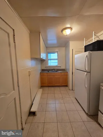a kitchen with a refrigerator a stove top oven and a refrigerator