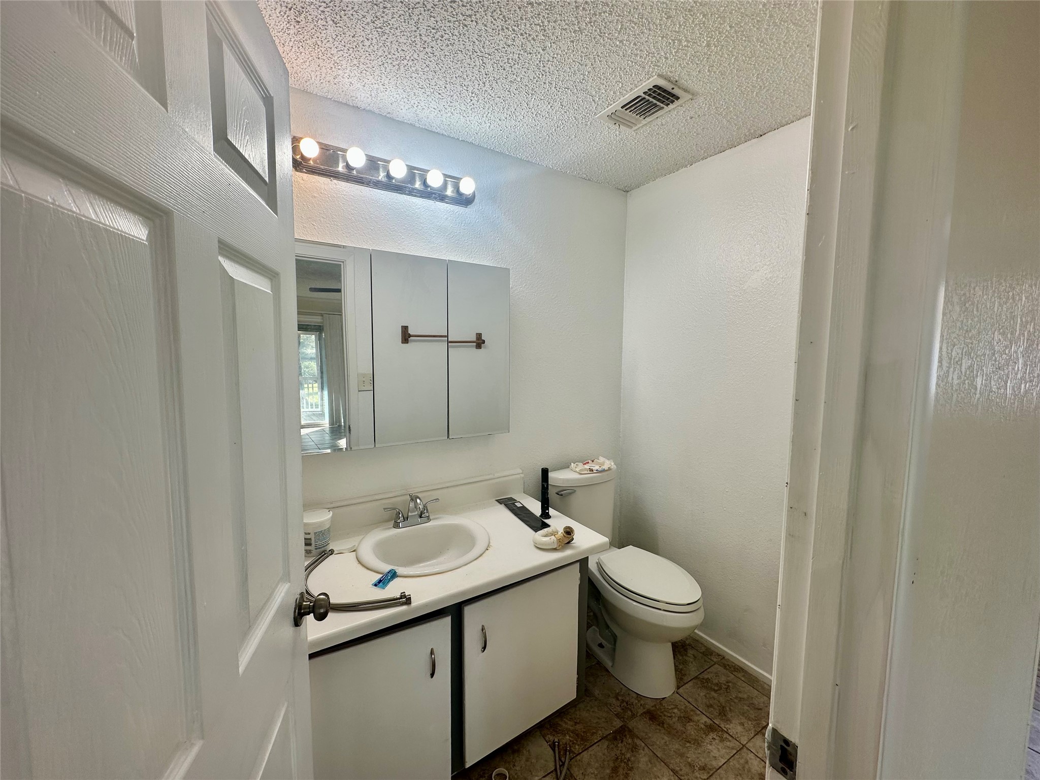1414 Angle Road Angleton, TX 77515 - Photo 13 of 24 a bathroom with a granite countertop sink a toilet and a mirror