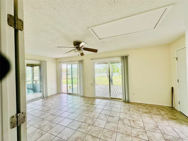 a view of a hallway with a chandelier fan