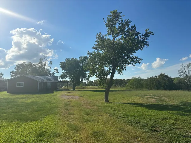 a backyard of a house with lots of green space