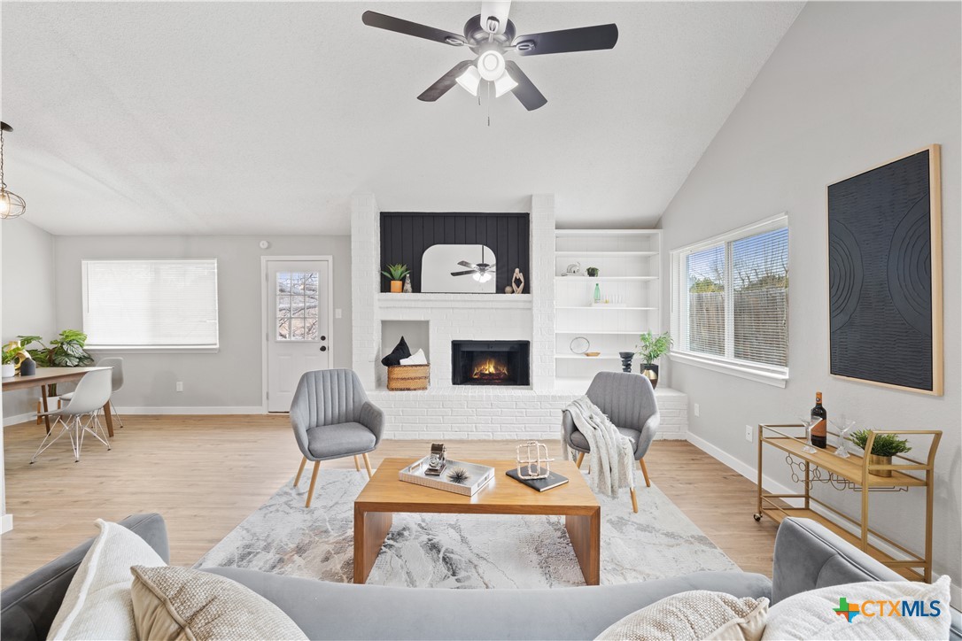 a living room with furniture and a fireplace